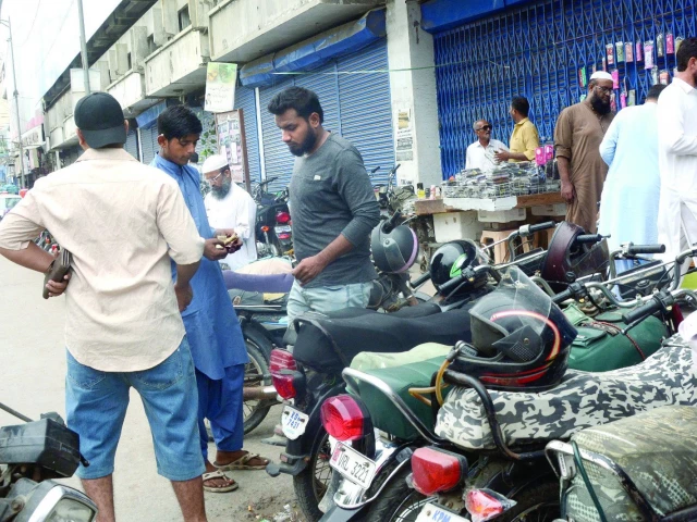 despite an official ban by the kmc and sindh government a man continues to collect parking fees from motorcyclists in saddar raising questions about enforcement on the ground photo express despite an official ban by the kmc and sindh government a man continues to collect parking fees from motorcyclists in saddar raising questions about enforcement on the ground photo express