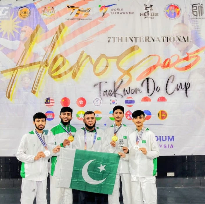 the karachi taekwondo academy team raising green flag high at the international taekwondo cup