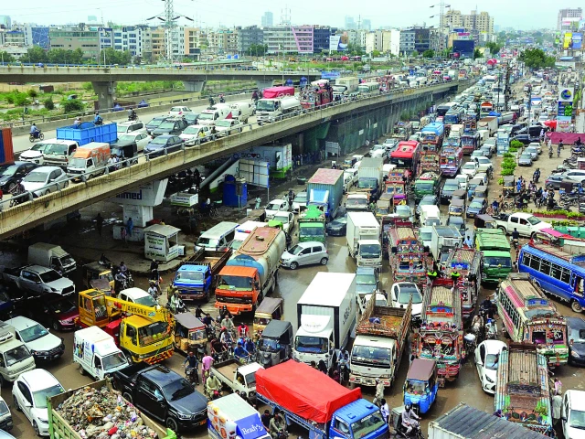 flood induced closures of korangi crossing and ebm causeway bring the city s traffic to a standstill stranding commuters for hours on key routes photo jalal qureshi express