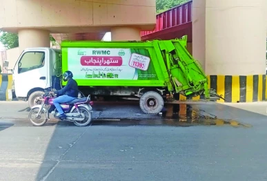 a vehicle belonging to the rawalpindi waste management company rwmc is found parked on a main road the vehicle is leaking oil spilling foul smelling wastewater and carrying waste in excess of its designated capacity photo express