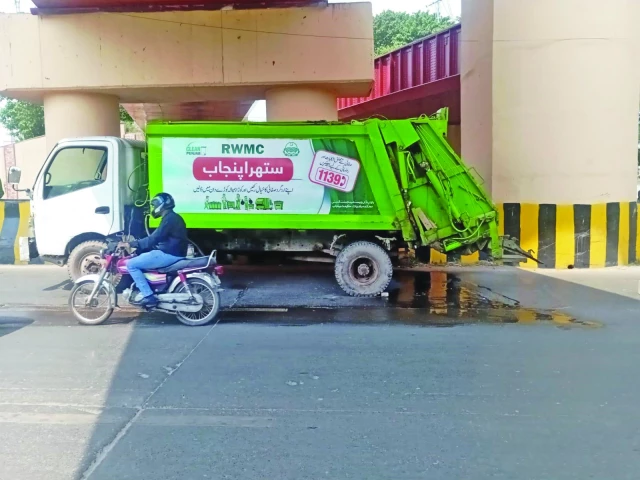 a vehicle belonging to the rawalpindi waste management company rwmc is found parked on a main road the vehicle is leaking oil spilling foul smelling wastewater and carrying waste in excess of its designated capacity photo express