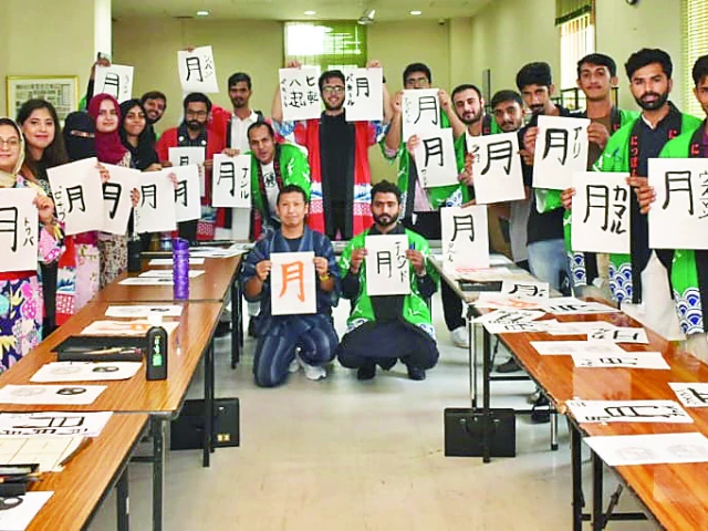 students donning traditional kimonos practice calligraphy and learn to use chopsticks during a cultural exchange event hosted by the japanese embassy in the federal capital photo express