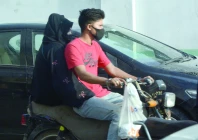 a biker though without helmet wears a mask on a dusty and windy day in the port city on wednesday photo jalal qureshi express