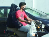 a biker though without helmet wears a mask on a dusty and windy day in the port city on wednesday photo jalal qureshi express