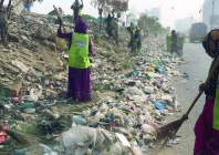dozens of sindh solid waste management board workers and vehicles descend on the korangi expressway to clean the trash on friday after publication of news about piles of garbage in the express photo express