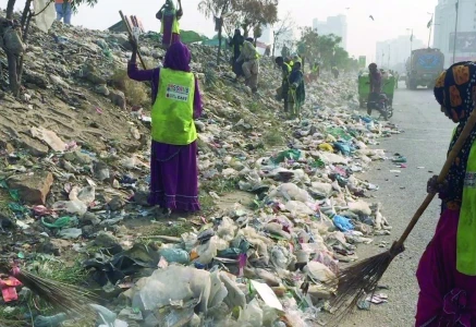 dozens of sindh solid waste management board workers and vehicles descend on the korangi expressway to clean the trash on friday after publication of news about piles of garbage in the express photo express