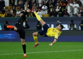 al nassr s cristiano ronaldo right strikes the ball to score his team s fourth goal during the saudi pro league football match between al nassr and al khaleej at al awwal park in riyadh on november 23 2025 photo afp