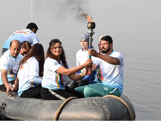 olympian sadaf siddiqui along with other participants holds the torch during the 35th national games torch relay ceremony at rawal lake islamabad app