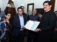 sindh cm murad ali shah presents a birth certificate to a parent during a launch of the civil registration management system crms mobile application at cm house in karachi on november 28 photo ppi
