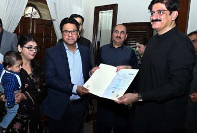 sindh cm murad ali shah presents a birth certificate to a parent during a launch of the civil registration management system crms mobile application at cm house in karachi on november 28 photo ppi