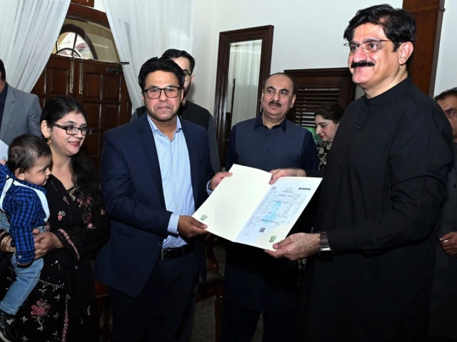 sindh cm murad ali shah presents a birth certificate to a parent during a launch of the civil registration management system crms mobile application at cm house in karachi on november 28 photo ppi