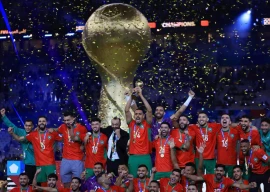 morocco players and coach tarik sektioui celebrate on the podium as soufiane bouftini lifts the trophy photo reuters