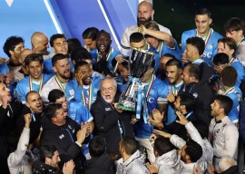 napoli players and staff celebrate on the podium as president aurelio de laurentiis lifts the supercoppa italiana trophy photo reuters