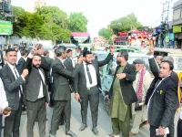 lawyers stage protest on ma jinnah road on tuesday over registration of fir against lawyers who allegedly attacked youtuber rajab butt in the city courts premises on monday photo express