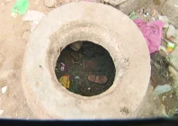 a tiny shoe is visible in the sludge of the uncovered choked gutter in which eight year old dilbar ali died on monday photo express