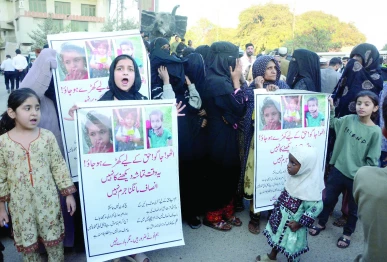 traffic comes to a standstill on garden nishtar road as families along with kids protest a year of police inaction demanding justice and the safe return of aliyan and ali raza photo jalal qureshi express