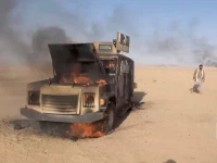 houthi fighters move next to a destroyed vehicle following what the source described as an attack on saudi backed forces in the location given by the source as al jawf governorate yemen in this screengrab taken from a video released by houthi military media on september 15 2026 photo reuters