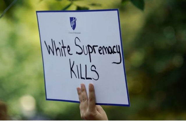 a woman holds a sign during a rally against guns and white supremacy in the wake of mass shootings in dayton and el paso in front of the white house in washington u s august 6 2019 photo reuters a woman holds a sign during a rally against guns and white supremacy in the wake of mass shootings in dayton and el paso in front of the white house in washington u s august 6 2019 photo reuters