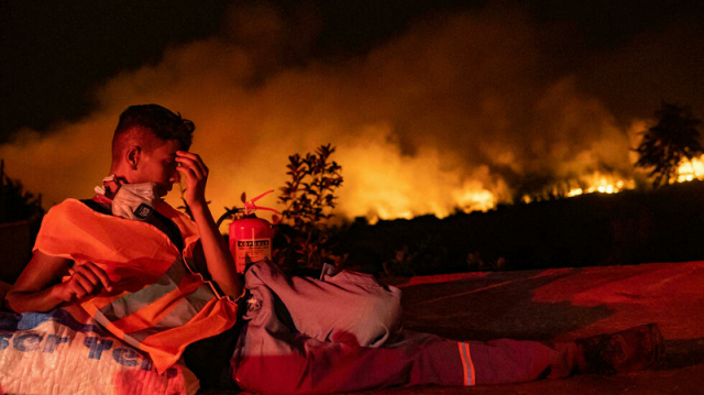mass evacuations as greek fires rage but turkey saved by the rain