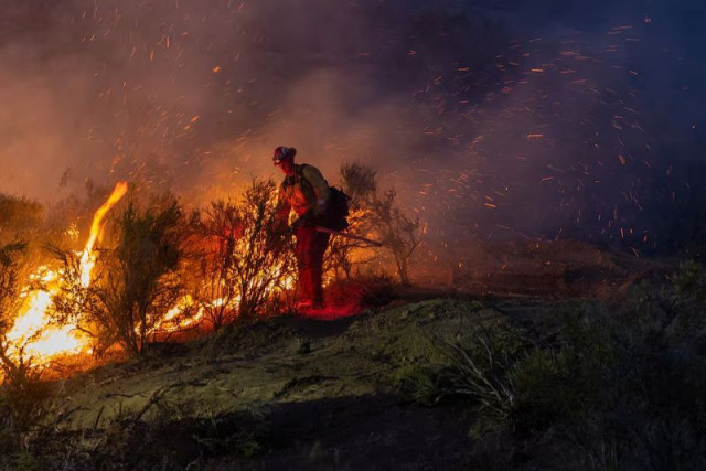 a firefighter battles the sites fire near lodoga california us june 17 2024 photo reuters a firefighter battles the sites fire near lodoga california us june 17 2024 photo reuters