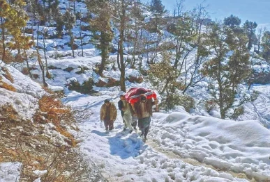 residents of a shangla village carry a patient on a charpoy to a hospital after heavy snowfall blocked roads in the remote mountainous district of khyber pakhtunkhwa photo express