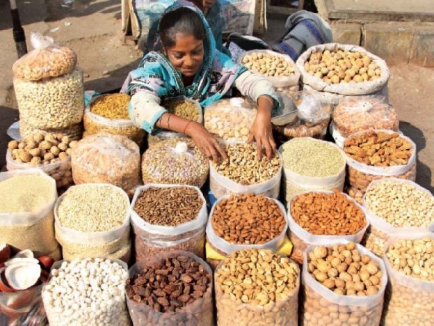 Women street vendor sells dry fruits in Saddar. PHOTO: AYSHA SALEEM/ EXPRESS