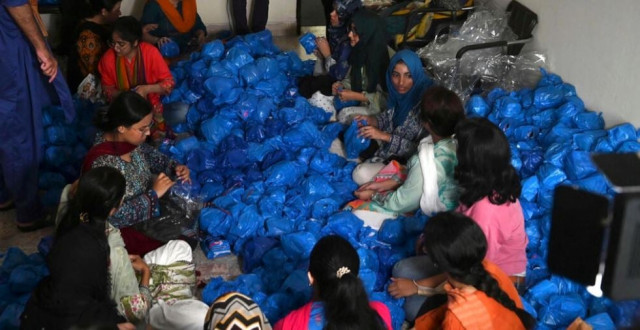 volunteers for the mahwari campaign pack sanitary products for women to be distributed to victims of the floods photo afp