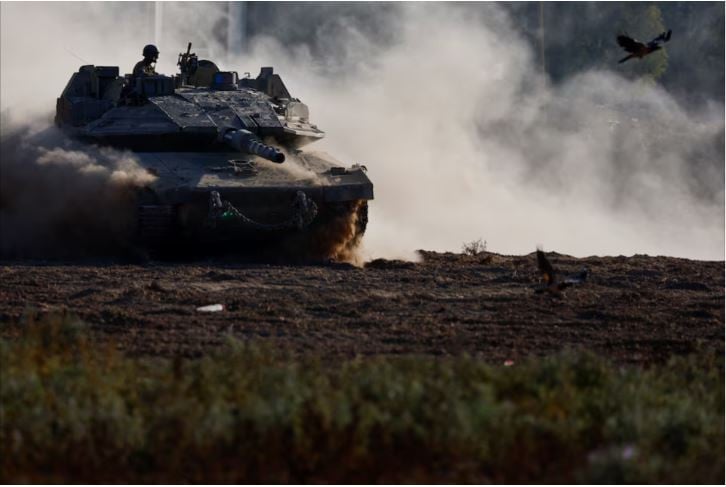 An Israeli tank manouvers near the Israel-Gaza border, amid the ongoing conflict between Israel and Hamas, in Israel, August 14, 2024. REUTERS/Amir Cohen