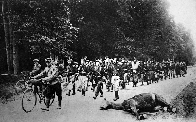 A file photo taken in 1916 shows a postcard released by the Historial de Peronne (WWI Museum) shows soldiers from the French North African colonies passing a dead horse, during the First World War. PHOTO: AFP