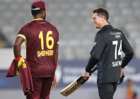 new zealand s mitchell santner r and west indies romario shepherd talk after the first twenty20 international cricket match at eden park in auckland on november 5 photo afp
