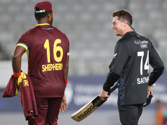 new zealand s mitchell santner r and west indies romario shepherd talk after the first twenty20 international cricket match at eden park in auckland on november 5 photo afp