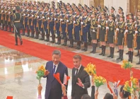 french president emmanuel macron gestures towards children next to china s president xi jinping at the great hall of the people in beijing photo afp