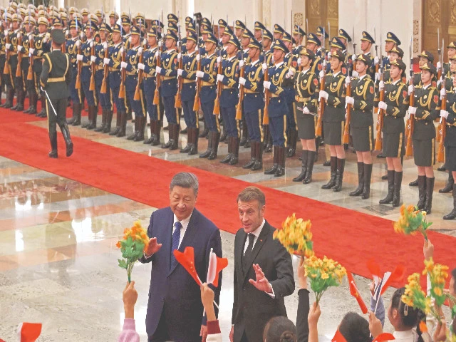 french president emmanuel macron gestures towards children next to china s president xi jinping at the great hall of the people in beijing photo afp french president emmanuel macron gestures towards children next to china s president xi jinping at the great hall of the people in beijing photo afp
