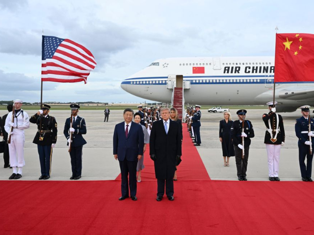 Chinese President Xi Jinping and US President Donald Trump standing for a photo on the red carpet. PHOTO: XINHUA