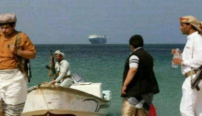 houthi fighters near red sea as a cargo vessel is in the background photo afp