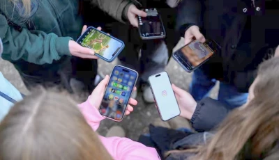 teenagers pose for a picture while looking at their phones in bonn germany february 20 2026 photo reuters
