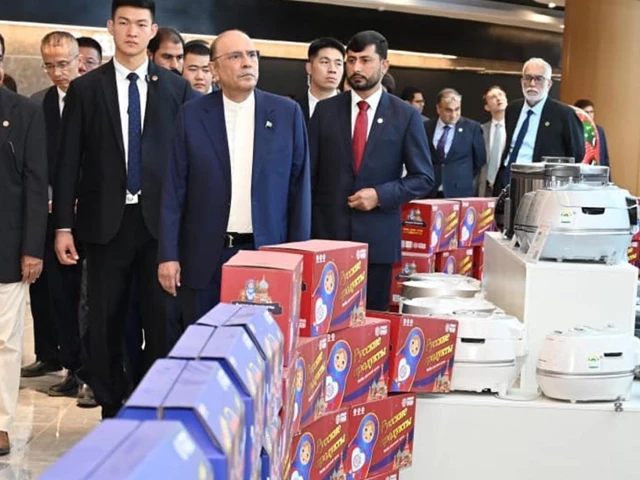 president asif ali zardari accompanied by chinese officials tours a trade exhibition featuring kitchen appliances and consumer goods during his visit to the kashgar free trade zone photo app