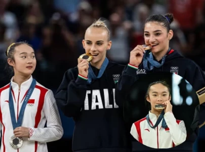 zhou yaqin chinese gymnast adorable metal biting moment goes viral at paris olympics 2024 zhou yaqin chinese gymnast adorable metal biting moment goes viral at paris olympics 2024