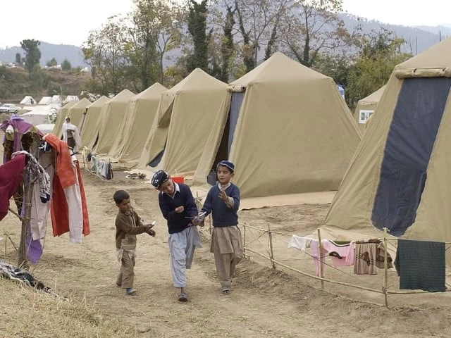 children playing outside afghan refugee camp photo file
