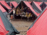 members of a family who fled from flooded banks of ravi river take shelter in a tent at a relief camp in lahore on august 31 2025 photo reuters